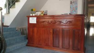 a wooden cabinet in a room with stairs at KhopChai Guesthouse in Ban Houayxay