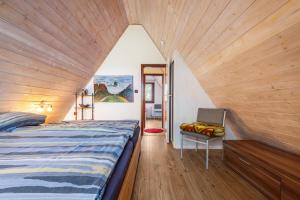 a bedroom with a bed and a chair in a room at Ferienhaus Elbidylle in Bachenbrock