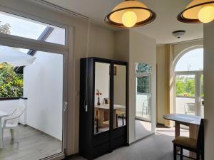 a hallway with a door leading to a dining room with a table at Hévíz,Dr Strecker Villa in Hévíz