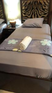 a bed with a blanket with flowers on it at 2 separate fully furnished condo units 1BR on the 23rd flr and 3BR penthouse on the 41st flr, with different bookings and daily rates in Ermita, Manila near SLEC,US Embassy, Mall and Parks in Manila