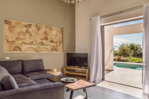 a living room with a couch and a television at Villa Vitalia in Lakithra