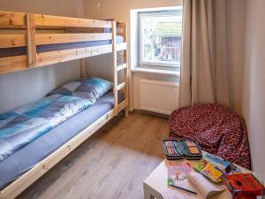 a room with two bunk beds and a table at Ferienwohnung Julia in Taching am See
