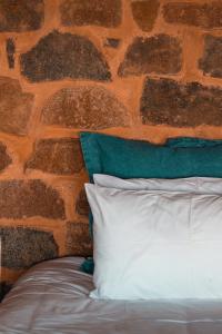 a white pillow sitting next to a brick wall at Woolly Bugger Farm in Tonteldoos
