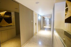 a hallway with a long corridor in a building at Pruthvi Paradise in Tumkūr