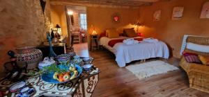 a bedroom with a bed and a table with food on it at Demeure de la Baronne in Vézénobres +42 photos