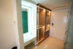 a bathroom with a glass shower and a window at Pruthvi Paradise in Tumkūr +45 photos
