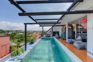a swimming pool on the balcony of a house at Beautiful Penthouse w/ incredible views, pool, & cinema room! in Canggu