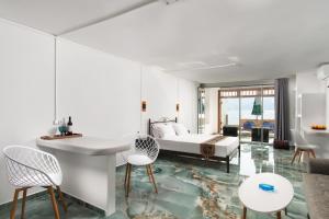a living room with a bed and a table and chairs at Deja Dream Homes in Schinopi