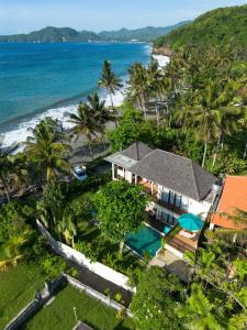 an aerial view of a house and the beach at Villa Sanika in Candidasa