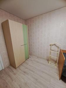 a room with a door and a chair next to a wall at 2-х комнатная Квартира возле Солнечной галлереи in Yekaterinovka