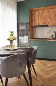 uma cozinha com uma mesa e cadeiras numa cozinha em 6 DOC Dream Apartment 6 +Parcare em Oradea