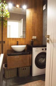 a bathroom with a sink and a washing machine at 6 DOC Dream Apartment 6 +Parcare in Oradea
