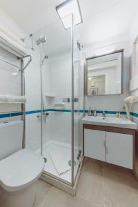 a bathroom with a shower and a toilet and a sink at Marvelous Seaview Holiday Home Kalkan in Kalkan