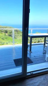 a view of a balcony with a view of the ocean at Amazing seaview apartment in Avliotes village Corfu in Avliótai