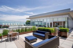 a patio with furniture and a building with glass at Tysons Corner 1br w concierge wd nr bars WDC-811 