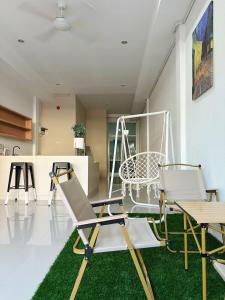a living room with two chairs and a swing at BeHome and Hostel in Chiang Mai