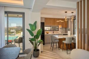 a kitchen with a table and chairs and a pool at Skyline Villa in Angeliana