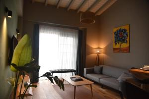 a living room with a couch and a table at Soas Suites in Alacati