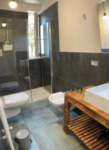 La salle de bains est pourvue de toilettes, d'un lavabo et d'une douche. dans l'établissement Casa degli Artisti, à Caprino Veronese