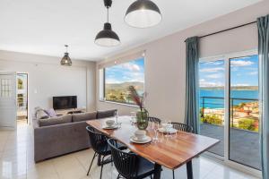a living room with a table and a couch at Amazing View Villa-Mathaios in Plaka -BY APOKORNAS VILLAS in Plaka +52 photos