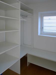 a room with white shelves and a window at Ferienwohnung Peterberg in Kirchzarten