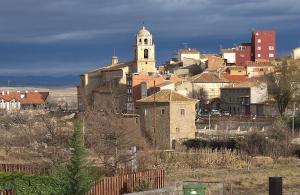a group of buildings and a church on a hill at Casa rural Abascal in Cella