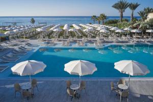 a large swimming pool with chairs and umbrellas at Atlantica Sungarden Park in Ayia Napa