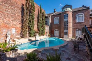 a swimming pool in front of a brick building at St. Philip Manor French Quarter in New Orleans