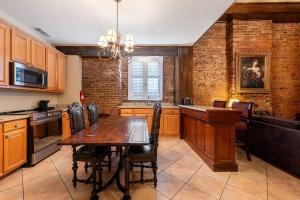 a kitchen with a wooden table and a dining room at St. Philip Manor French Quarter in New Orleans