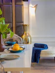 a table with a plate of fruit and a lamp at Residence ǁ Corino in Biograd na Moru