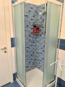 a shower with a glass door in a bathroom at Next Rest B&B in Selargius