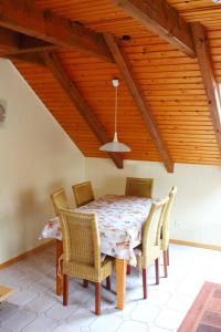 a dining room with a table and chairs and a ceiling at Seifert's Ferienwohnung Windrose 3 in Burhave in Burhave +44 photos