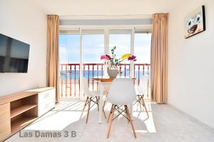 a dining room with a view of the ocean at Las Damas 3B Beach Front - Pool & Parking in Benidorm