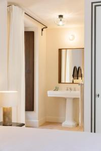 a bathroom with a sink and a mirror at Portella in Palma de Mallorca