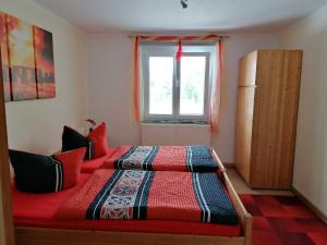 een slaapkamer met twee bedden en een raam bij Ferienwohnung Renner ca 100 qm in Mühlingen