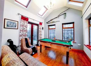a living room with a pool table in it at Knockmanagh Holiday Home in Kilcummin