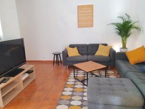 a living room with two couches and a flat screen tv at Villa Tassigny in Aix-en-Provence