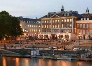 a group of buildings next to a body of water at Main Street Corner Great 1bedroom Flat - Richmond in London