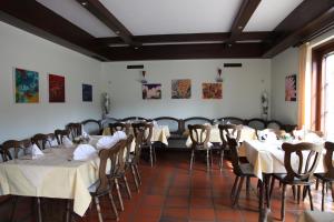 a dining room with tables and chairs in it at Hotel Bliesbrück in Herbitzheim
