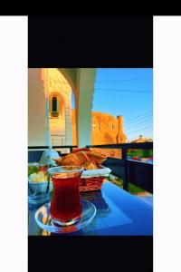a cup of tea on a table with a basket of food at Royal Goddess Guest House, Walled City in Famagusta
