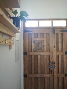 a wooden door in a room with a potted plant at Casa Rural Sierra Guadalcanal in Guadalcanal
