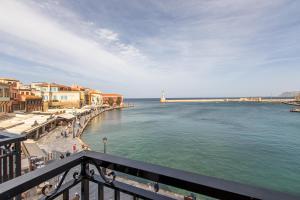 a view of a body of water with buildings and a pier at Lucia Hotel in Chania Town