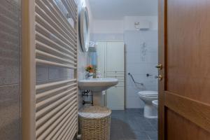 a bathroom with a sink and a toilet at San Gregorio Magno Apartment in Ferrara