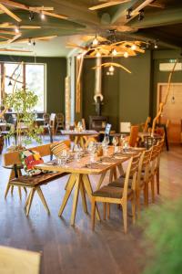 a dining room with wooden tables and chairs at Hotel Boka in Bovec