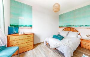 a bedroom with a bed and a dresser at 1 Bedroom Stunning Apartment In Melrand in Melrand