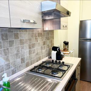 a kitchen with a stove top oven in a kitchen at Lawyer House Milan in Milan