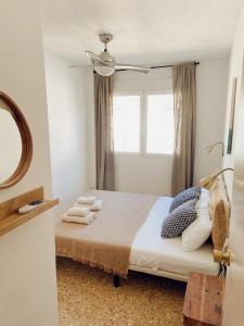 a bedroom with a bed with a window at Maison Dya Altea in Altea