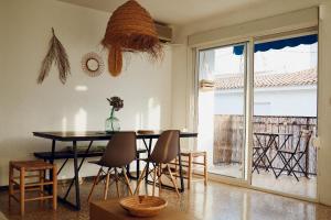 a dining room with a table and chairs and a window at Maison Dya Altea in Altea