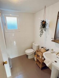 a bathroom with a toilet and a sink at Maison Dya Altea in Altea