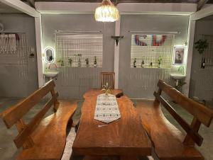 a dining room with a wooden table and two benches at Loyal friend hostel karimunjawa in Karimunjawa